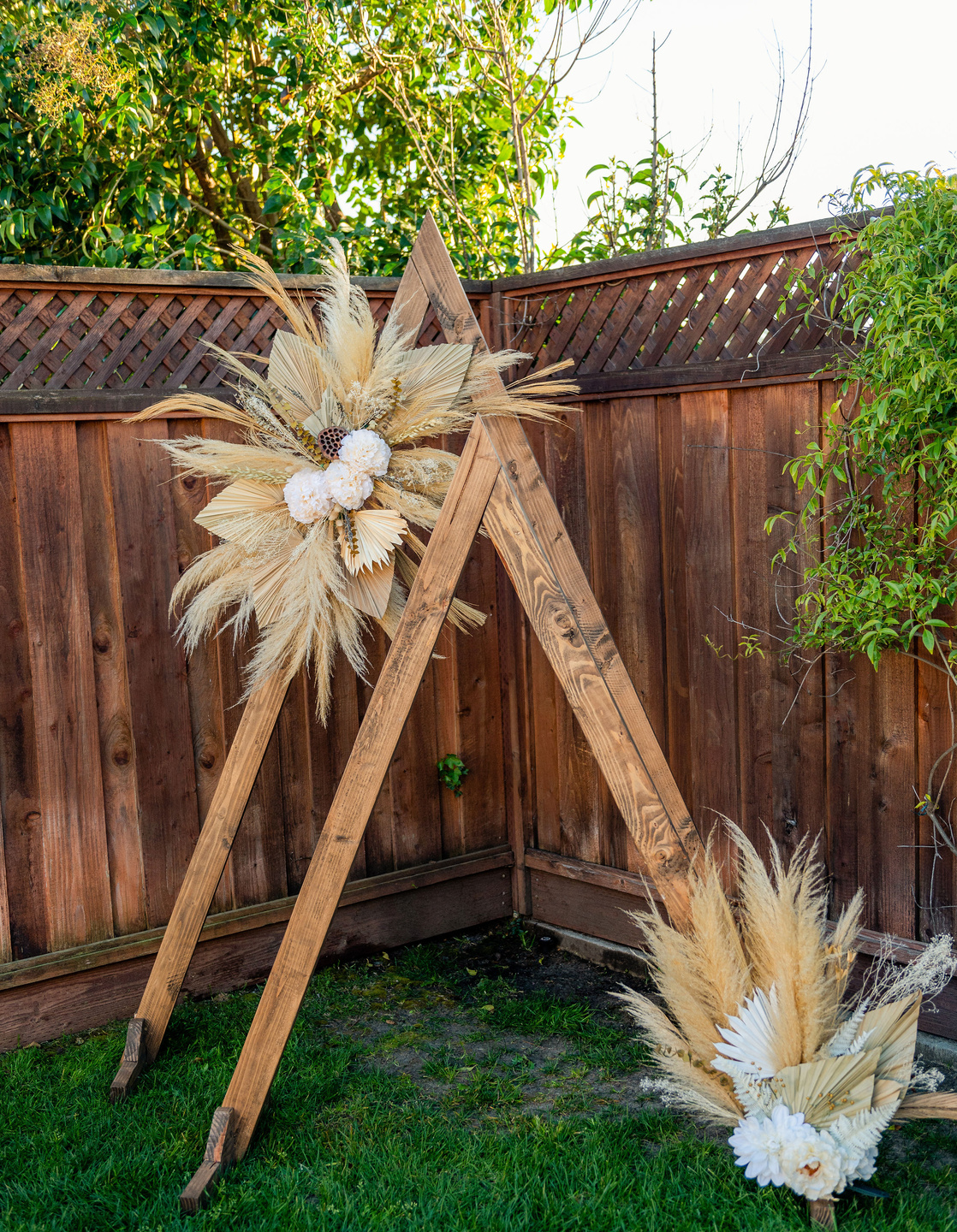 a natural wood triangle frame that can be rented for weddings, bridal showers or baby showers